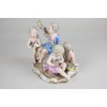 A Meissen porcelain figure group of four cherubs with garlands and baskets of flowers, crossed sword