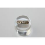 A diamond seven stone ring in 18ct yellow gold