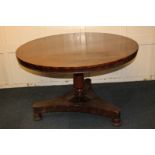 A Victorian mahogany circular breakfast table on turned and tapered stem, triform platform base