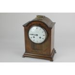 An Edwardian inlaid mahogany bracket mantel clock, domed top with brass handle, white enamel dial (