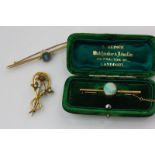 An opal bar brooch in fitted case, an aquamarine and seed pearl bar brooch, a pearl and ruby foliate