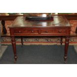 A Victorian mahogany rectangular writing table with inset leather top, two drawers, on turned legs