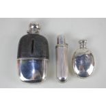 A Victorian silver and glass hip flask with twist top, brown leather mount and silver beaker,