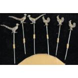 A cased set of six George V silver gilt stick pins, with three terminals in the form of cockerel,