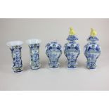 A set of faience pottery vases and urns, comprising two bud vases depicting women, two urns with