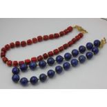 A lapis lazuli bead necklace with gilt clasp and spacers, a stained coral bead necklace