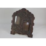 An early 20th century carved oak photograph frame, scrolling arched form with two rectangular panels