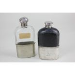 A silver topped cut glass spirit flask with foliated embossed screw top and engraved initials, and