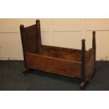 A wooden child's rocking cradle, 39.5cm by 91.5cm