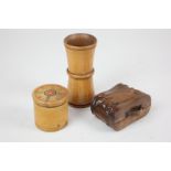 A small collection of treen comprising a novelty box formed as a binoculars case, a pot with screw