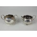 A George V silver cream jug, maker J Gillmore, Birmingham 1917, together with a silver sugar bowl,