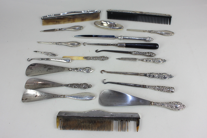 Three silver mounted combs, four silver handled shoe horns, together with various silver handled