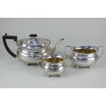 An Edward VII silver three-piece tea set of teapot, sugar bowl and cream jug, oval shape with gilt