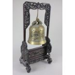 A Chinese brass bell on stand pierced with scrolling foliage, 44cm high, (a/f)
