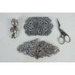 Two silver plated nurse's buckles with pierced designs (one a/f), a silver plated baby's rattle, and