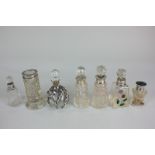 A collection of seven George V and later silver mounted cut glass scent and dressing table