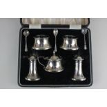 A George VI cased silver cruet set of two pepper pots, two salts, mustard pot and cover, with blue