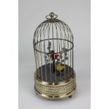 A 20th century clockwork wind-up automation of two singing birds in a gilt cage