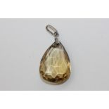 A citrine pendant, the faceted pear shape drop on a plain mount