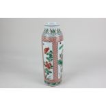 A Chinese porcelain baluster vase decorated in green and red with panels of flowers and foliage on a
