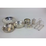 A pair of George V small silver circular dishes, London 1927, 11cm, a four-division toast rack,