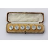 A cased set of six 15ct gold, diamond and mother of pearl dress buttons