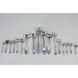 A collection of sixteen George III and later silver condiment salt and mustard spoons, including one