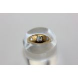 A diamond three stone ring in 18ct yellow gold