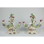 A pair of 19th century Continental porcelain baskets modelled with a green parrot on foliage and