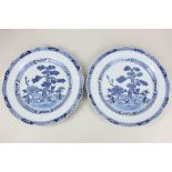 A pair of Chinese blue and white porcelain plates, each with scalloped rim and central circular