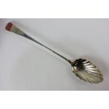 A George IV silver serving spoon with shell cast bowl and long Old English pattern handle, maker's