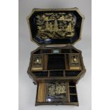 A Chinese black lacquer octagonal work box depicting figures in a garden, the fitted interior with