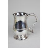 A George III silver tankard, baluster shape with reeded girdle and scroll handle with engraved