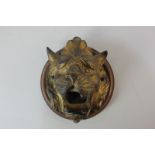 A 19th century gilt brass wall plaque of a roaring lions head 15cm