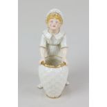 A Victorian Royal Worcester Kate Greenaway figure of a girl standing behind a wicker basket,