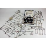 A large collection of Continental silver, white metal and silver plated spoons, tongs and sifter