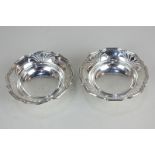 A pair of George VI silver circular bonbon dishes with pierced scalloped borders, on pedestal bases,
