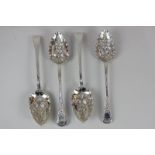 A set of four George IV silver berry tablespoons, later decoration of embossed floral bowls and