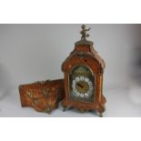 A reproduction gilt mounted marquetry bracket clock in dome case with cherub surmount, on scroll