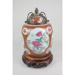 A Chinese porcelain baluster vase and cover, the base with three drilled holes, decorated with