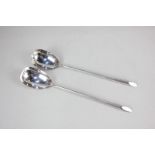 A pair of Edward VII silver salad servers, oval bowls with long tapered handles, maker William