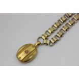 A late 19th century gold and coral oval locket on an associated rectangular and hoop link chain,