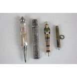 A silver gilt and enamel 'Egyptian mummy' slide pencil, a silver pencil case, two pencils