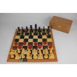 An H P Gibson & Sons Ltd chess and draughts board with Staunton pattern chess set and black and