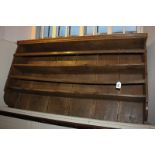 A 19th century rustic wall shelf with oak plank back 122cm wide