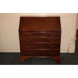 A George III mahogany bureau, the fall enclosing a fitted interior above four graduated drawers with