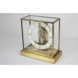 A Junghans Ato mantel clock in square glass and brass case, 22cm