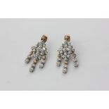 A pair of diamond drop earrings in 18ct white and yellow gold