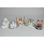 Three various Staffordshire pottery pastille burners comprising a castle and two cottages, largest