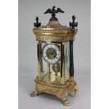 An Empire style gilt metal mantel clock with 10cm gilt and white enamel dial with Roman numerals, in